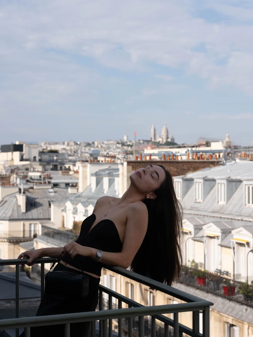 Diana on a balcony overlooking Paris rooftops