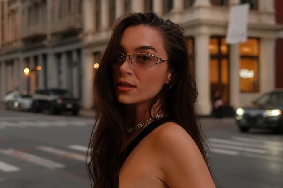 Diana outdoors wearing glasses and a dark sleeveless outfit